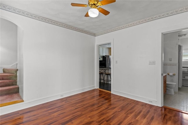167 Carter Ave, Pawtucket, RI 02861 - spare room featuring a ceiling fan, stairway, wood finished floors, and arched walkways