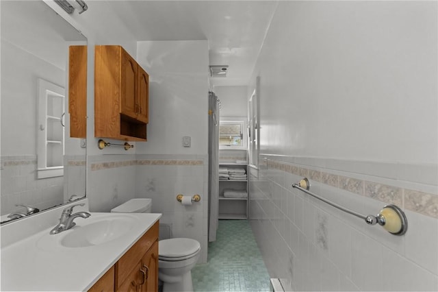 167 Carter Ave, Pawtucket, RI 02861 - bathroom featuring vanity, tile walls, and a wainscoted wall