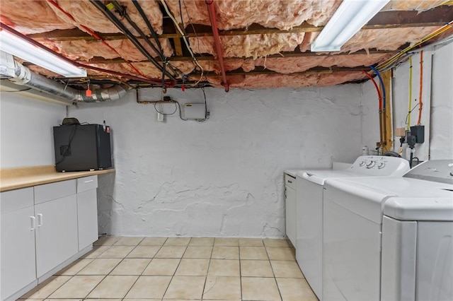 167 Carter Ave, Pawtucket, RI 02861 - washroom featuring washer and dryer, cabinet space, and light tile patterned floors