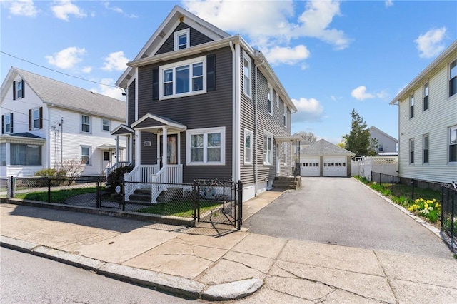 167 Carter Ave, Pawtucket, RI 02861 - view of front facade featuring a garage, a fenced front yard, a gate, and a residential view