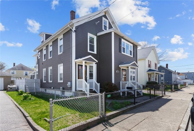 167 Carter Ave, Pawtucket, RI 02861 - view of front of home with a residential view, a chimney, and a fenced front yard