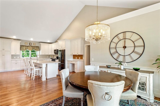 42 Aubin St, Seekonk, MA 02771 - dining area with a chandelier, high vaulted ceiling, light wood-style flooring, and recessed lighting