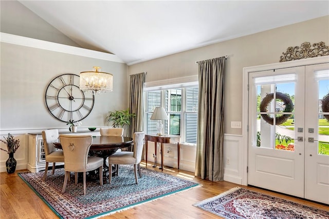 42 Aubin St, Seekonk, MA 02771 - dining room with plenty of natural light, a chandelier, light wood-type flooring, lofted ceiling, and wainscoting