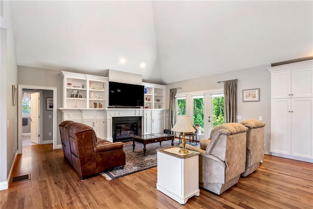 42 Aubin St, Seekonk, MA 02771 - living room with plenty of natural light, light wood-style flooring, a glass covered fireplace, high vaulted ceiling, and recessed lighting
