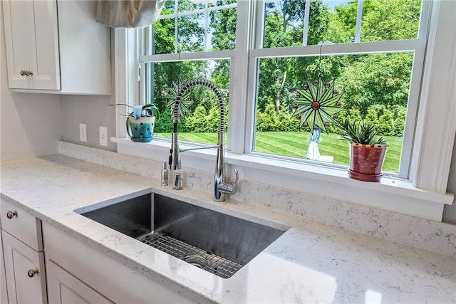 42 Aubin St, Seekonk, MA 02771 - kitchen featuring white cabinetry and light stone countertops