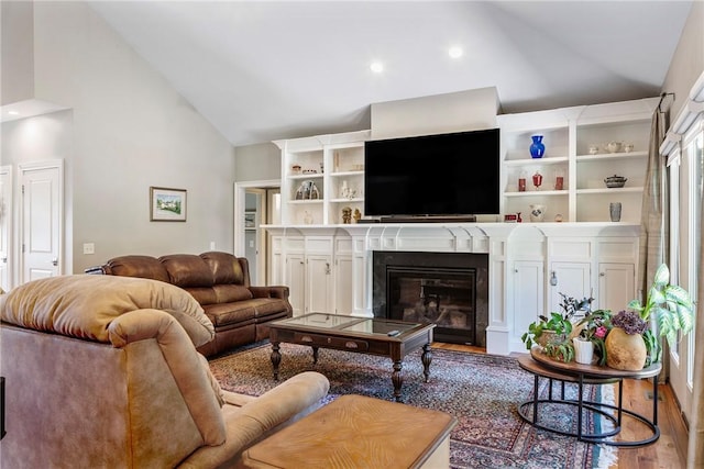 42 Aubin St, Seekonk, MA 02771 - living area with high vaulted ceiling, wood finished floors, and a fireplace