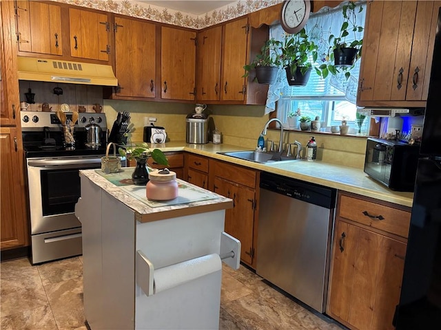70 Partition St, Warwick, RI 02888 - kitchen with appliances with stainless steel finishes, under cabinet range hood, light countertops, and brown cabinetry