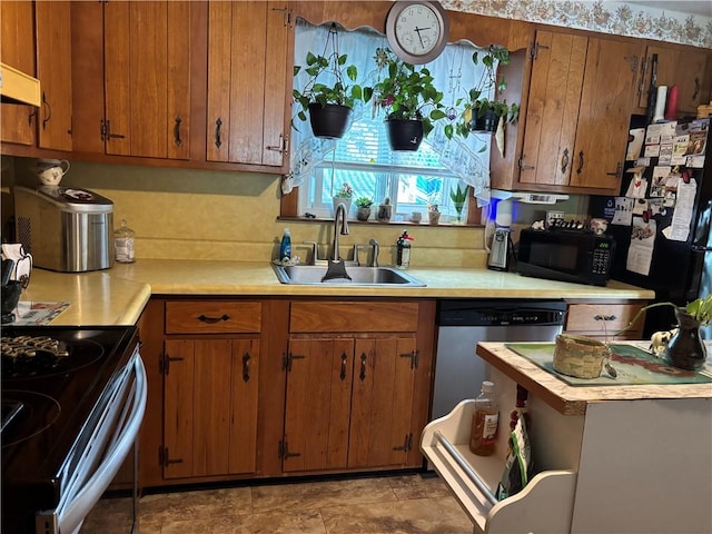 70 Partition St, Warwick, RI 02888 - kitchen featuring light countertops, black appliances, brown cabinets, and range hood