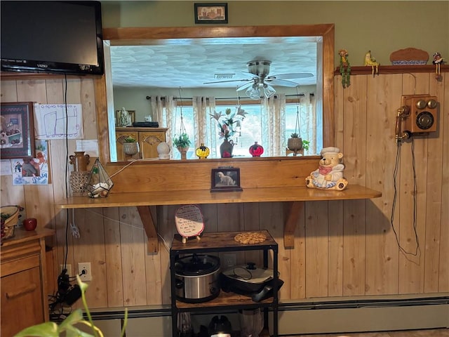 70 Partition St, Warwick, RI 02888 - detailed view of a baseboard heating unit, a ceiling fan, and wood walls