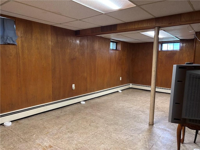 70 Partition St, Warwick, RI 02888 - basement featuring tile patterned floors, wooden walls, healthy amount of natural light, baseboard heating, and a paneled ceiling