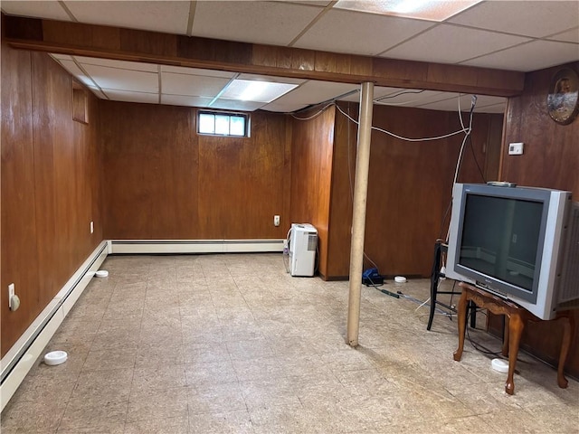 70 Partition St, Warwick, RI 02888 - basement with wood walls, a paneled ceiling, tile patterned floors, and a baseboard heating unit