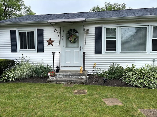 70 Partition St, Warwick, RI 02888 - doorway to property with a yard and a shingled roof