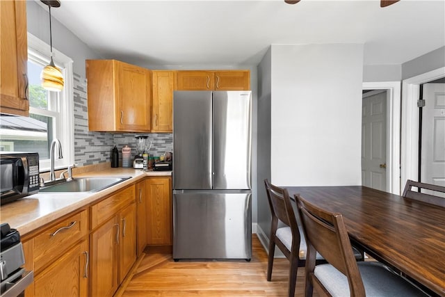 166 Midwood St, Cranston, RI 02910 - kitchen featuring freestanding refrigerator, black microwave, light countertops, light wood-type flooring, and range
