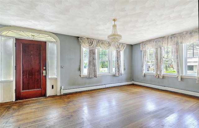 59 Colonial Ave, Cranston, RI 02910 - foyer with wood-type flooring, baseboard heating, and a chandelier