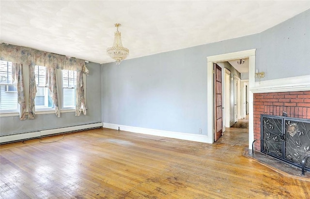 59 Colonial Ave, Cranston, RI 02910 - unfurnished living room featuring wood-type flooring, a chandelier, a fireplace, and a baseboard radiator