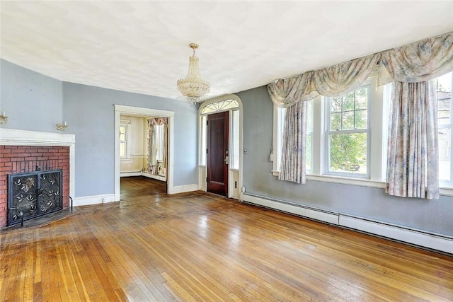 59 Colonial Ave, Cranston, RI 02910 - unfurnished living room with a baseboard radiator, a chandelier, hardwood / wood-style floors, and a fireplace