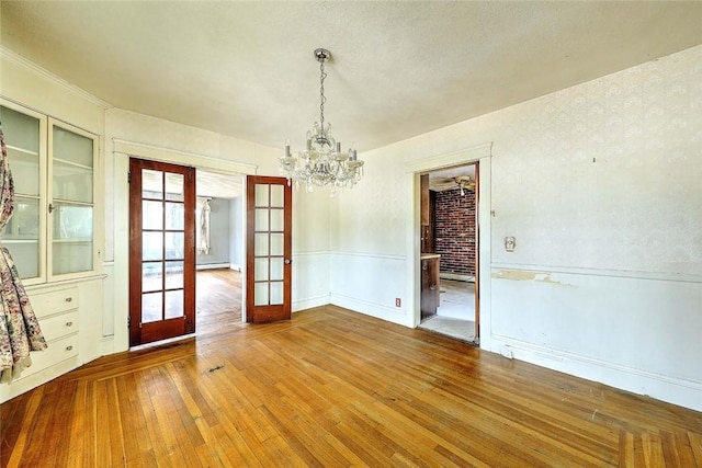 59 Colonial Ave, Cranston, RI 02910 - unfurnished dining area featuring french doors, hardwood / wood-style flooring, and a chandelier
