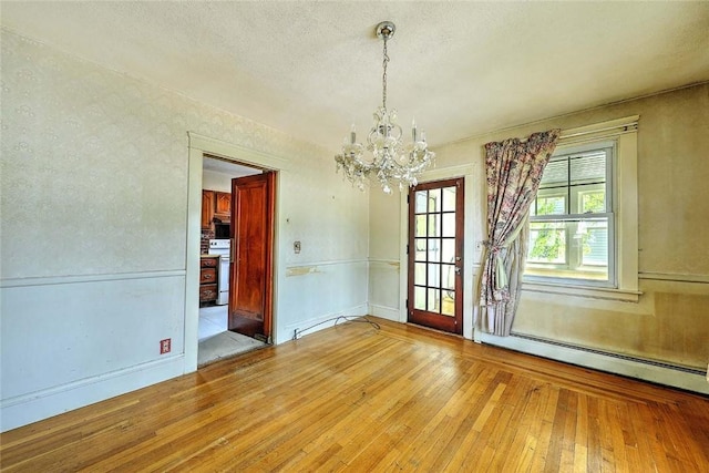 59 Colonial Ave, Cranston, RI 02910 - unfurnished dining area featuring a chandelier, hardwood / wood-style flooring, a baseboard heating unit, and a textured ceiling