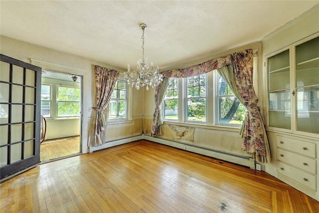59 Colonial Ave, Cranston, RI 02910 - unfurnished dining area featuring a chandelier, healthy amount of natural light, wood-type flooring, and baseboard heating