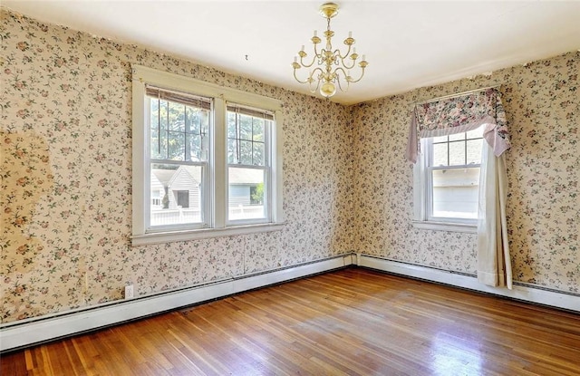 59 Colonial Ave, Cranston, RI 02910 - spare room with wood finished floors, plenty of natural light, a chandelier, and wallpapered walls