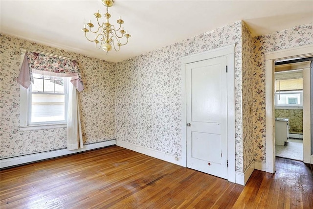 59 Colonial Ave, Cranston, RI 02910 - spare room featuring wood-type flooring, wallpapered walls, a baseboard heating unit, healthy amount of natural light, and a chandelier