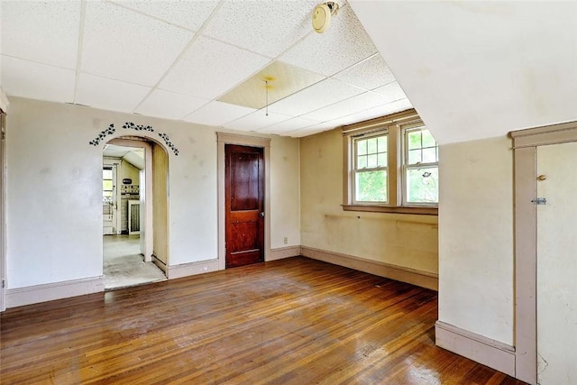 59 Colonial Ave, Cranston, RI 02910 - empty room featuring a paneled ceiling, wood-type flooring, and arched walkways