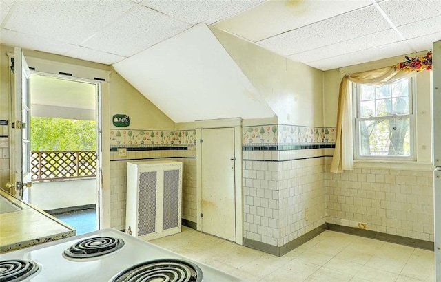 59 Colonial Ave, Cranston, RI 02910 - kitchen featuring a drop ceiling, light floors, tile walls, white electric range, and wainscoting