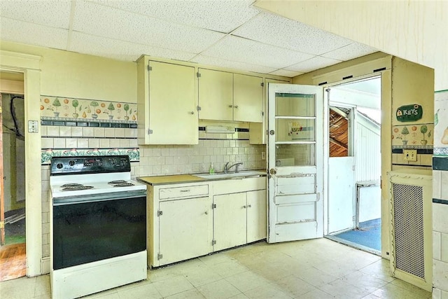 59 Colonial Ave, Cranston, RI 02910 - kitchen featuring electric stove, a drop ceiling, light flooring, cream cabinets, and light countertops