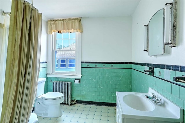 59 Colonial Ave, Cranston, RI 02910 - bathroom featuring radiator, tile walls, vanity, a wainscoted wall, and tile patterned floors