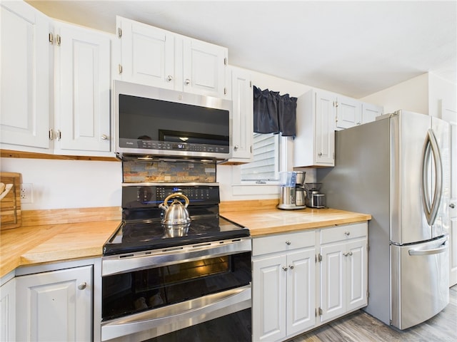 34 Beach Plum Rd, Narragansett, RI 02882 - kitchen featuring appliances with stainless steel finishes, wood counters, and white cabinets