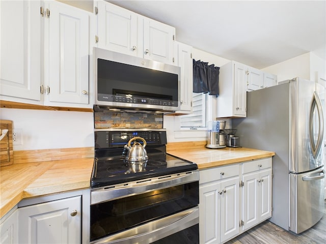 34 Beach Plum Rd, Narragansett, RI 02882 - kitchen featuring appliances with stainless steel finishes, butcher block countertops, white cabinets, and light wood finished floors