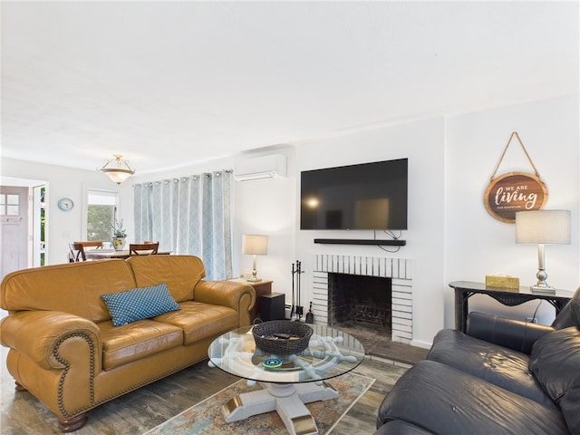 34 Beach Plum Rd, Narragansett, RI 02882 - living area with wood finished floors, a wall mounted AC, and a brick fireplace