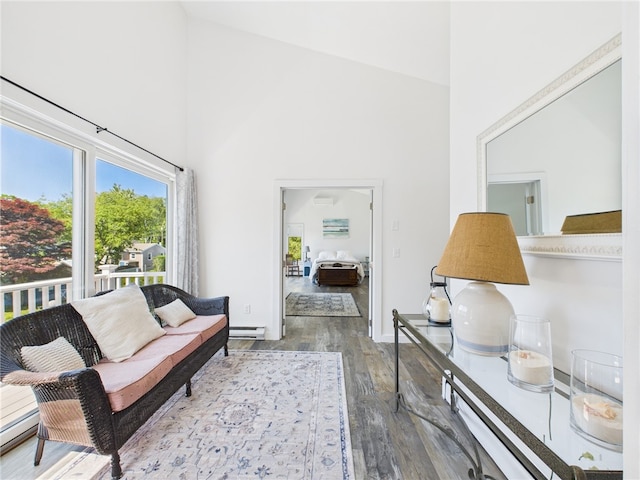 34 Beach Plum Rd, Narragansett, RI 02882 - living area featuring a towering ceiling, wood finished floors, and baseboard heating