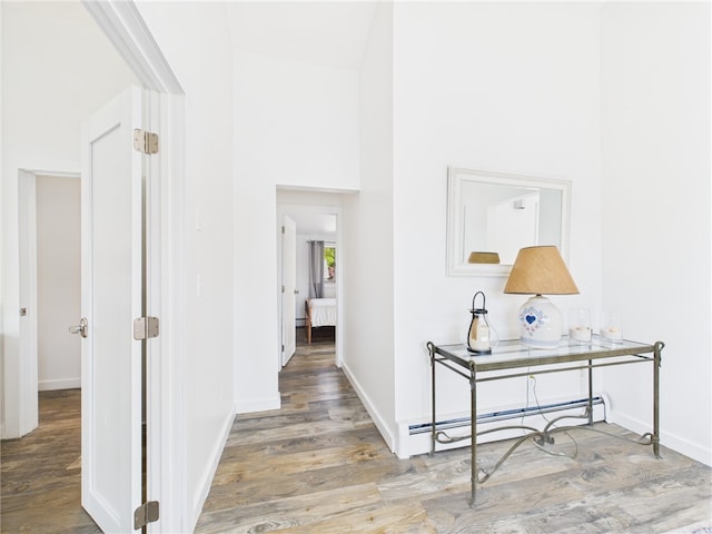 34 Beach Plum Rd, Narragansett, RI 02882 - hallway with wood finished floors and a baseboard heating unit