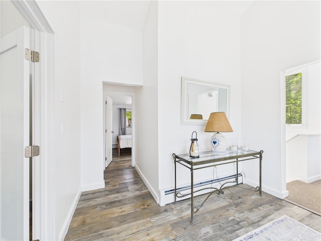34 Beach Plum Rd, Narragansett, RI 02882 - hall featuring plenty of natural light, a towering ceiling, wood finished floors, and baseboard heating