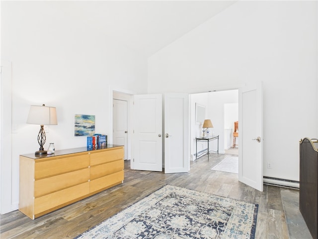 34 Beach Plum Rd, Narragansett, RI 02882 - bedroom with high vaulted ceiling, a baseboard radiator, and wood finished floors