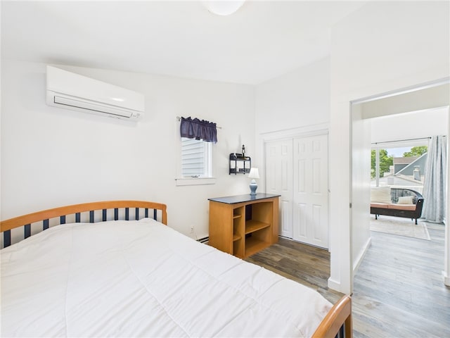 34 Beach Plum Rd, Narragansett, RI 02882 - bedroom featuring a wall mounted AC, wood finished floors, a closet, and a baseboard radiator