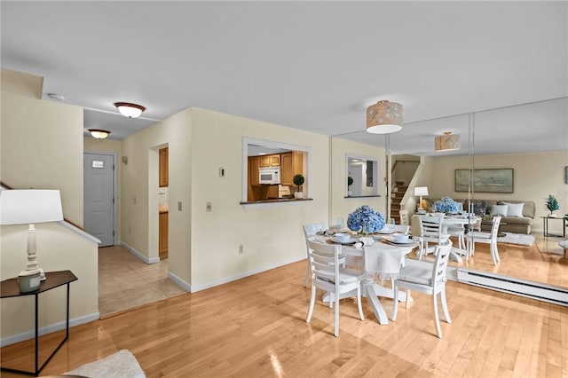 180 Fishing Cove Rd, North Kingstown, RI 02852 - dining space with stairs and light wood-style floors