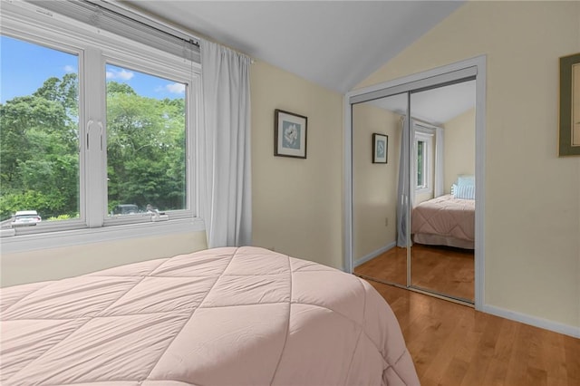 180 Fishing Cove Rd, North Kingstown, RI 02852 - bedroom featuring vaulted ceiling, a closet, and wood finished floors