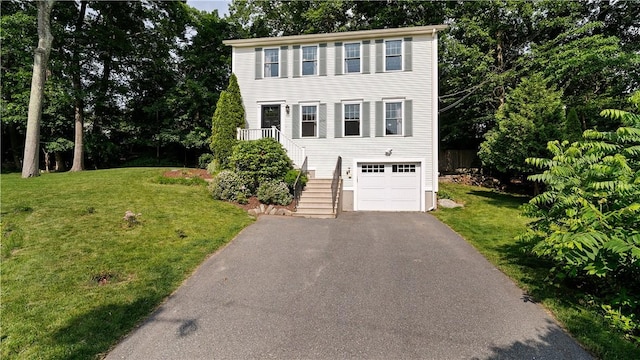 28 Narragansett Rd, Cumberland, RI 02864 - colonial inspired home featuring stairway, asphalt driveway, a front yard, and an attached garage