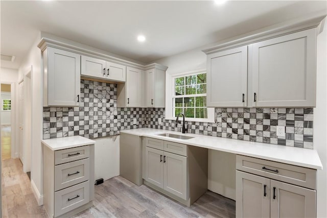 226 Quaker Ln, Scituate, RI 02857 - kitchen with light wood-style floors, tasteful backsplash, recessed lighting, and gray cabinetry