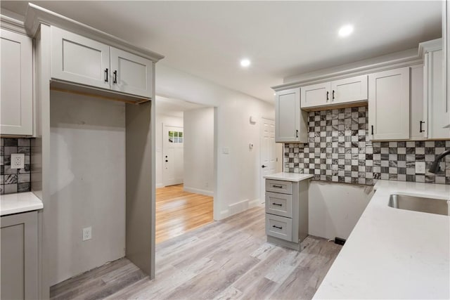 226 Quaker Ln, Scituate, RI 02857 - kitchen with gray cabinets, decorative backsplash, light wood-style flooring, light countertops, and recessed lighting