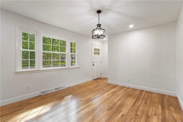 226 Quaker Ln, Scituate, RI 02857 - unfurnished dining area featuring a chandelier and light wood-style flooring