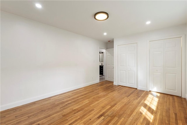 226 Quaker Ln, Scituate, RI 02857 - unfurnished bedroom with two closets, light wood finished floors, and recessed lighting