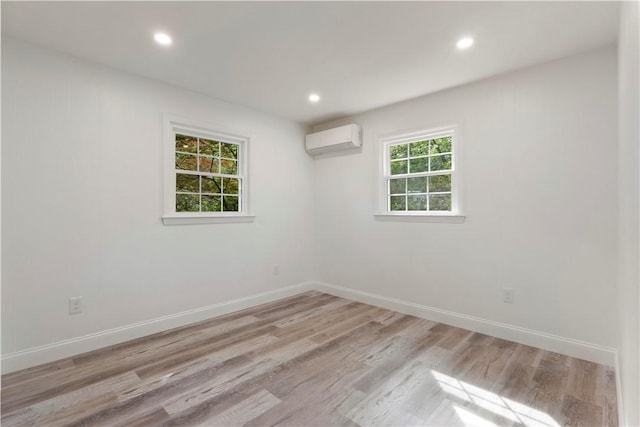 226 Quaker Ln, Scituate, RI 02857 - unfurnished room with a wall mounted AC, light wood finished floors, and recessed lighting