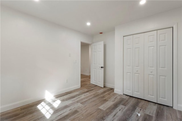 226 Quaker Ln, Scituate, RI 02857 - unfurnished bedroom with wood finished floors, recessed lighting, and a closet