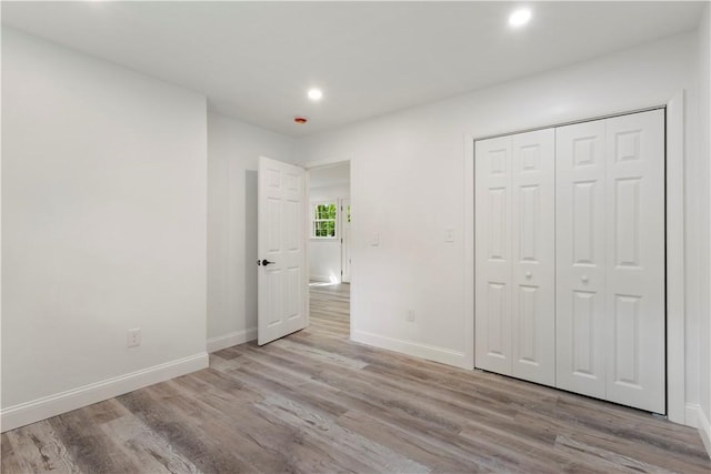226 Quaker Ln, Scituate, RI 02857 - unfurnished bedroom with wood finished floors, recessed lighting, and a closet