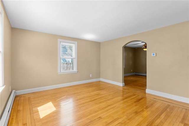 74 Park View Blvd, Cranston, RI 02910 - unfurnished room featuring a baseboard radiator, light wood-type flooring, arched walkways, and a ceiling fan
