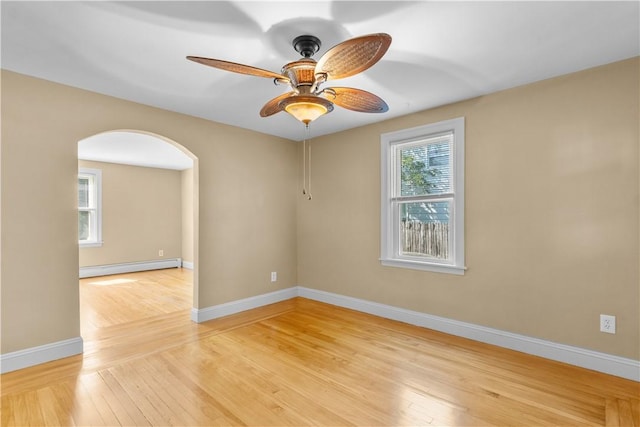 74 Park View Blvd, Cranston, RI 02910 - spare room with baseboard heating, arched walkways, light wood-type flooring, and a ceiling fan