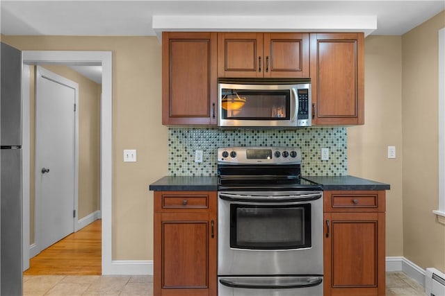 74 Park View Blvd, Cranston, RI 02910 - kitchen with appliances with stainless steel finishes, dark countertops, backsplash, and brown cabinets